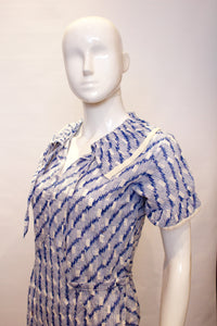 A vintage 1920s blue and white printed summer day dress