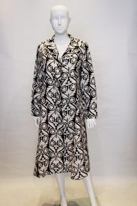 A vintage 1960s black and white graphic print duster coat