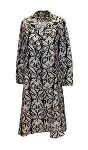 A vintage 1960s black and white graphic print duster coat