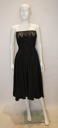 A Vintage 1950s black strapless Cocktail Dress